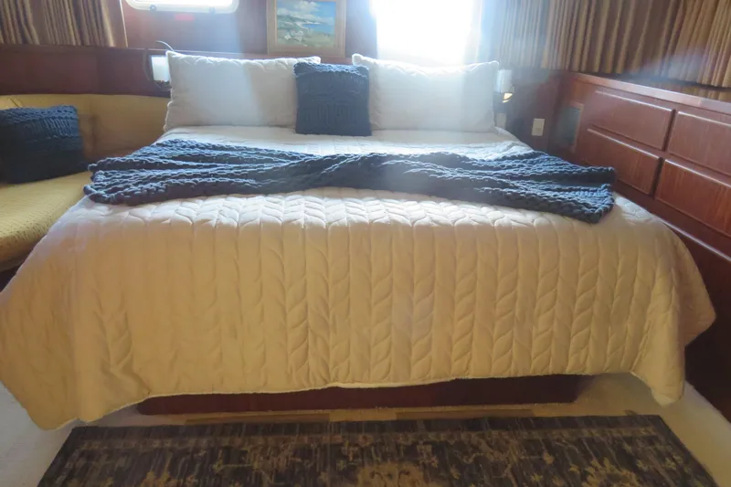 Slide: The Image of Cozy bedroom interior of 1986 Hatteras 58 Motor Yacht with elegant bedding. - 35