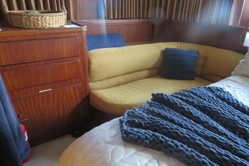 Slide: The Image of Interior of 1986 Hatteras 58 Motor Yacht with cozy seating and knitted decor. - 36