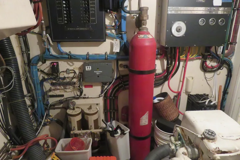 Slide: The Image of Engine room of a 1986 Hatteras 58 Motor Yacht with control panels and equipment. - 40