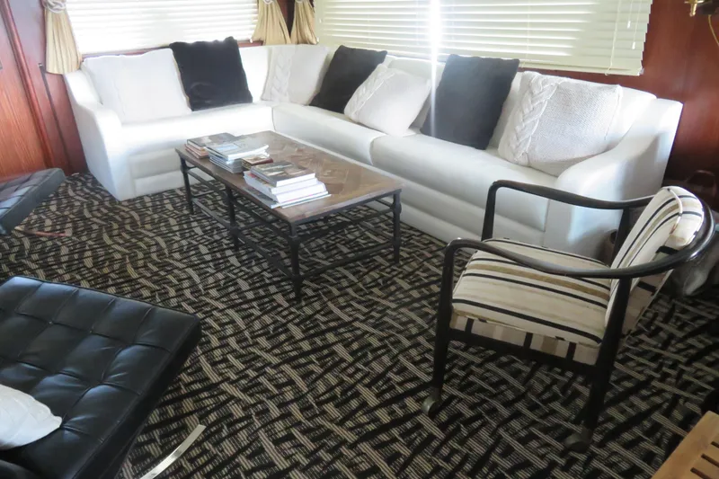 Slide: The Image of Luxurious interior of 1986 Hatteras 58 Motor Yacht with elegant seating and decor. - 5