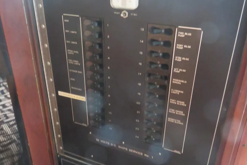Slide: The Image of Electrical panel on a 1986 Hatteras 58 Motor Yacht, showing switches and labels. - 52
