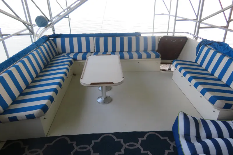Slide: The Image of 1986 Hatteras 58 Motor Yacht interior with blue and white striped seating. - 55