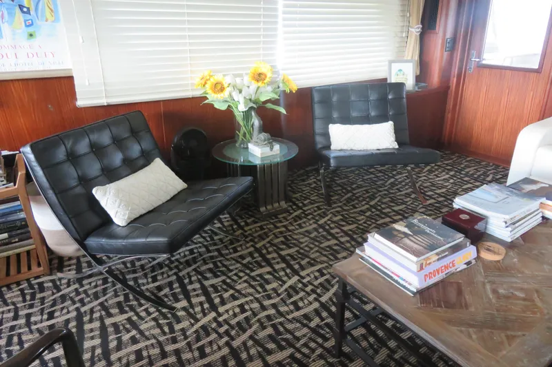 Slide: The Image of Interior of 1986 Hatteras 58 Motor Yacht with modern chairs and decor. - 6