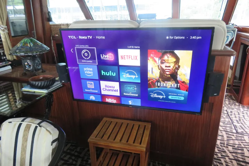 Slide: The Image of TCL Roku TV in 1986 Hatteras 58 Motor Yacht interior, displaying streaming apps. - 7