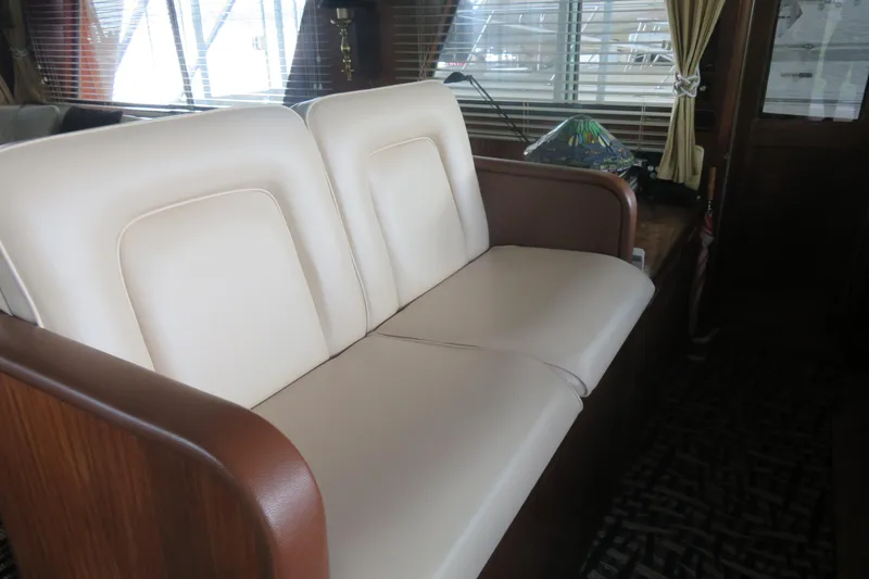 Slide: The Image of Interior of 1986 Hatteras 58 Motor Yacht with cream leather seating and wooden accents. - 8
