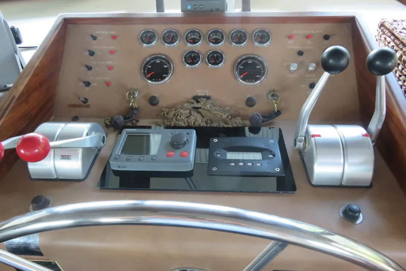 Slide: The Image of Control panel of a 1986 Hatteras 58 Motor Yacht with gauges and levers. - 9