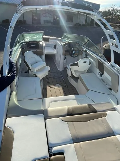 Slide: The Image of 2022 Chaparral 23 SSi boat interior with seating and steering wheel. - 10