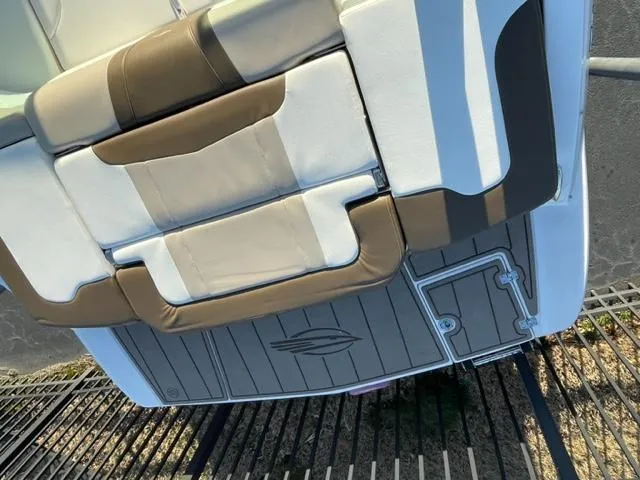 Slide: The Image of 2022 Chaparral 23 SSi boat interior with brown and white seating. - 11
