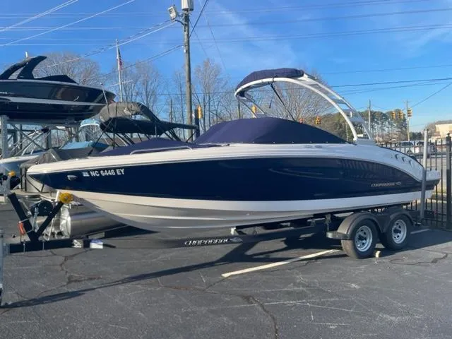 Slide: The Image of 2022 Chaparral 23 SSi boat on trailer, blue and white design, parked outdoors. - 3