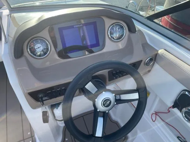 Slide: The Image of 2022 Chaparral 23 SSi boat dashboard with steering wheel and digital display. - 6