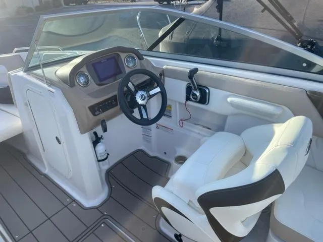 Slide: The Image of 2022 Chaparral 23 SSi boat interior with steering wheel and dashboard controls. - 8