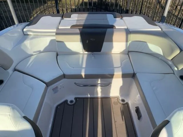 Slide: The Image of 2022 Chaparral 23 SSi boat interior with cushioned seating and storage compartments. - 9