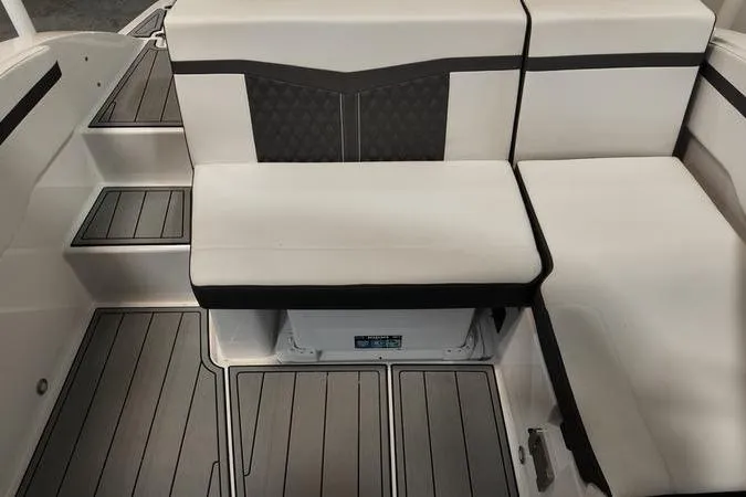 Slide: The Image of 2024 Monterey M-225 boat interior with cushioned seating and sleek flooring design. - 10