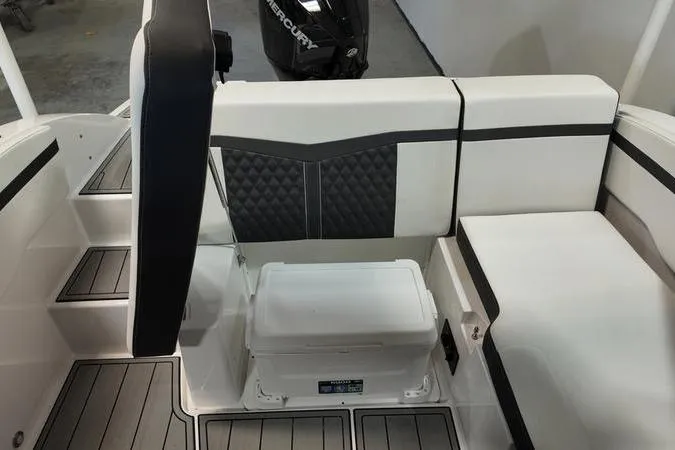 Slide: The Image of 2024 Monterey M-225 boat interior with cushioned seating and storage area. - 11