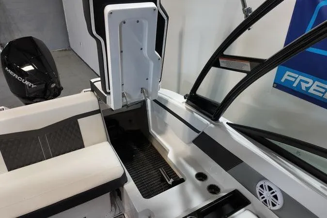 Slide: The Image of 2024 Monterey M-225 boat interior with seating, Mercury engine, and modern design elements. - 13