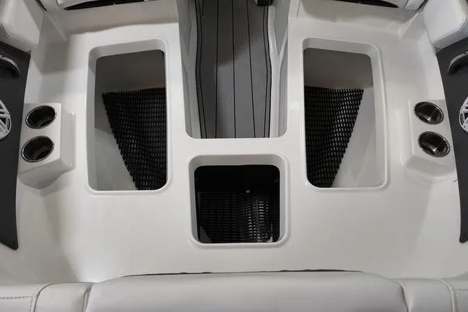 Slide: The Image of 2024 Monterey M-225 boat interior with cup holders and storage compartments. - 26
