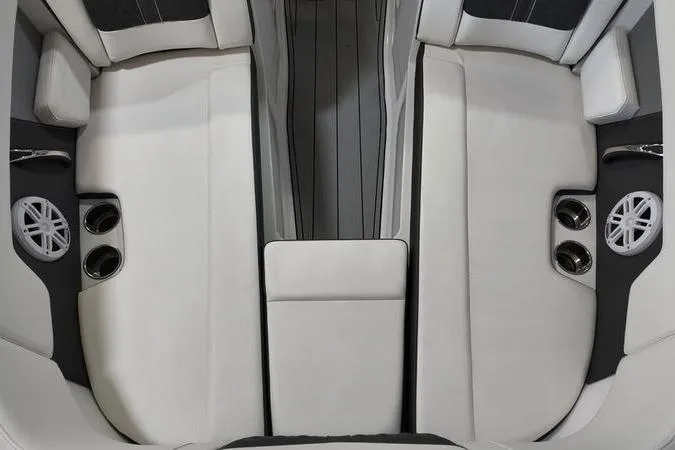 Slide: The Image of 2024 Monterey M-225 boat interior with white seating, cup holders, and speakers. - 27