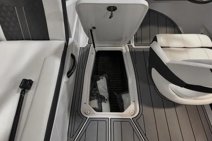 Slide: The Image of 2024 Monterey M-225 boat interior with open storage compartment and seating. - 29