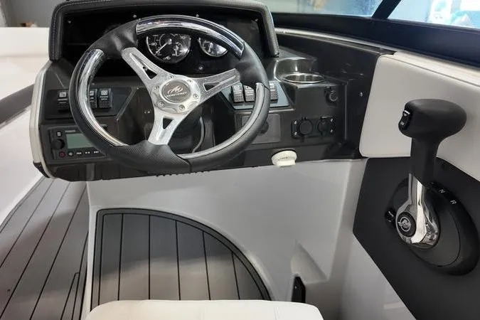 Slide: The Image of 2024 Monterey M-225 boat cockpit with steering wheel and control panel. - 30