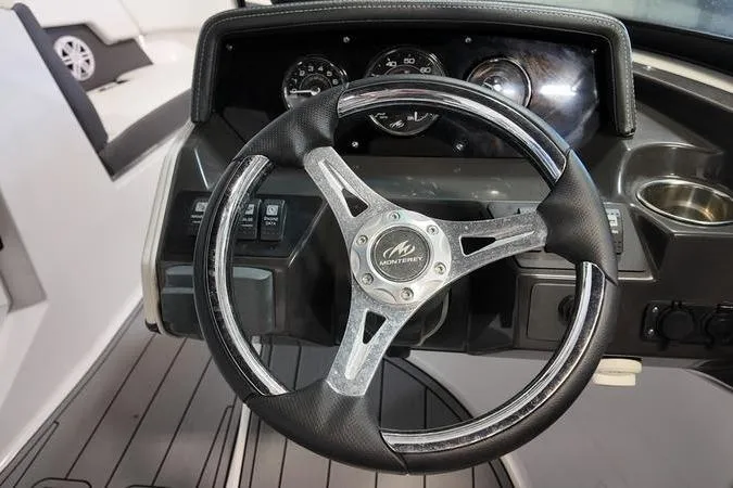 Slide: The Image of Steering wheel of 2024 Monterey M-225 boat, featuring sleek dashboard design. - 31
