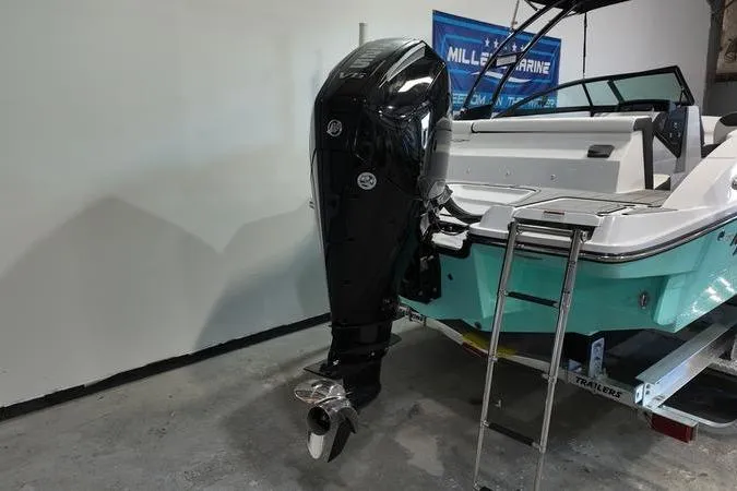 Slide: The Image of 2024 Monterey M-225 boat with outboard motor and swim ladder on trailer. - 4