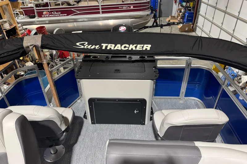 Slide: The Image of 2026 Sun Tracker Fishin' Barge 20 DLX interior with seating and control panel. - 11