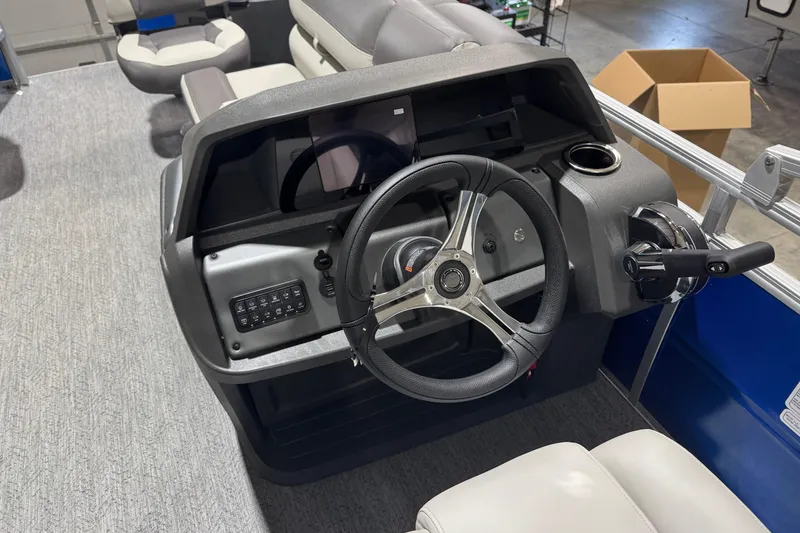 Slide: The Image of 2026 Sun Tracker Fishin' Barge 20 DLX steering console with modern controls and seating. - 12