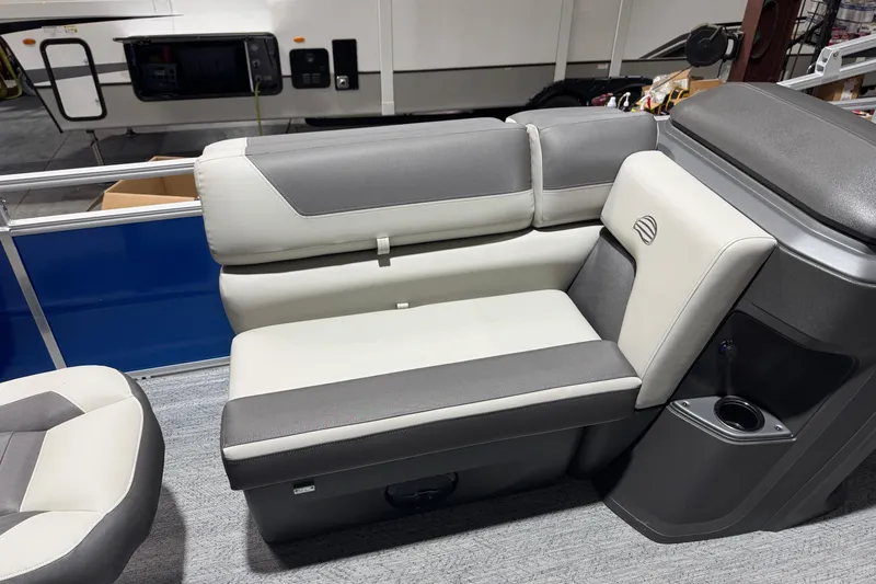 Slide: The Image of 2026 Sun Tracker Fishin' Barge 20 DLX interior seating with gray and white upholstery. - 8