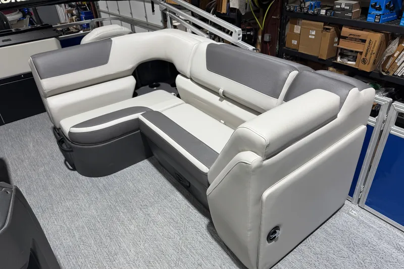 Slide: The Image of 2026 Sun Tracker Fishin' Barge 20 DLX interior seating, featuring gray and white upholstery. - 9