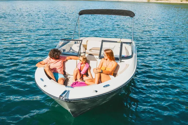 Slide: The Image of Manufacturer Provided Image: Family enjoying a sunny day on a 2025 Bayliner V20i boat. - 2