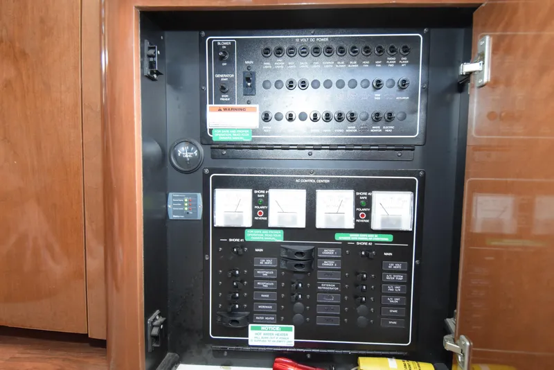 Slide: The Image of Electrical control panel inside a 2008 Carver 36 Mariner boat, featuring switches and gauges. - 13