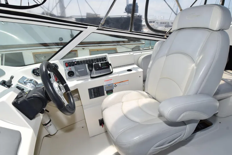 Slide: The Image of Captain's seat and helm of 2008 Carver 36 Mariner yacht, featuring modern controls and steering. - 21