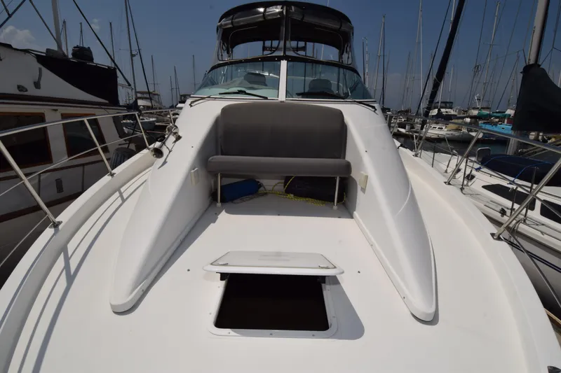 Slide: The Image of 2008 Carver 36 Mariner yacht docked at marina, showcasing spacious deck and seating area. - 23
