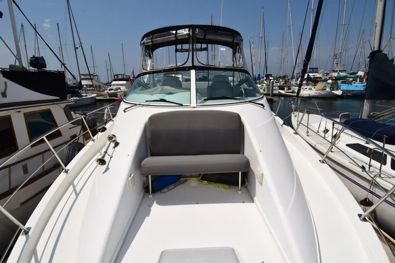 Slide: The Image of 2008 Carver 36 Mariner yacht docked in a marina, featuring a spacious deck. - 24