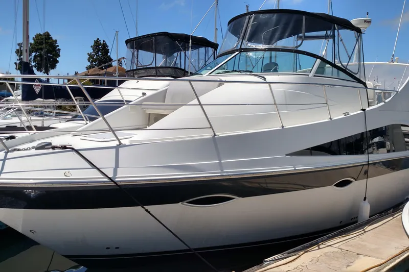 Slide: The Image of 2008 Carver 36 Mariner yacht docked at marina under clear blue sky. - 3