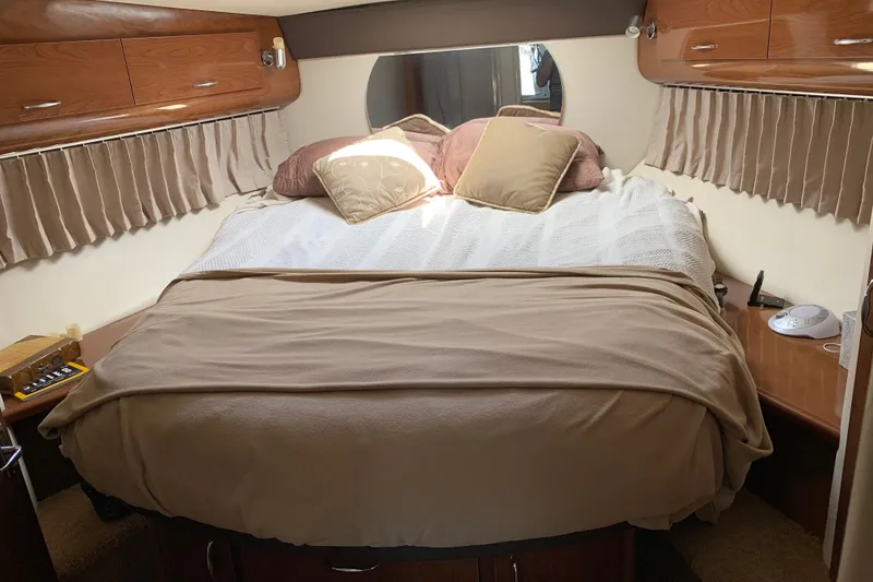 Slide: The Image of Cozy bedroom interior of 2008 Carver 36 Mariner yacht with plush bedding and wooden cabinets. - 6