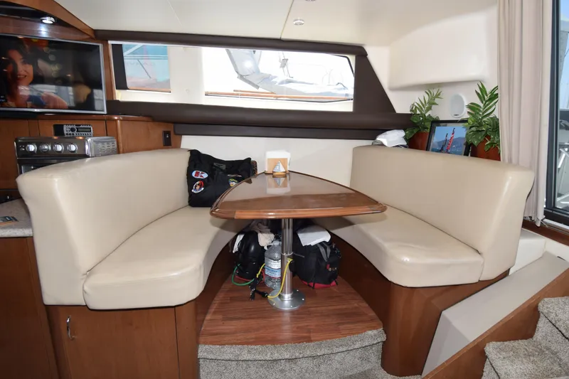 Slide: The Image of Interior of 2008 Carver 36 Mariner yacht with cozy dining area and modern amenities. - 7