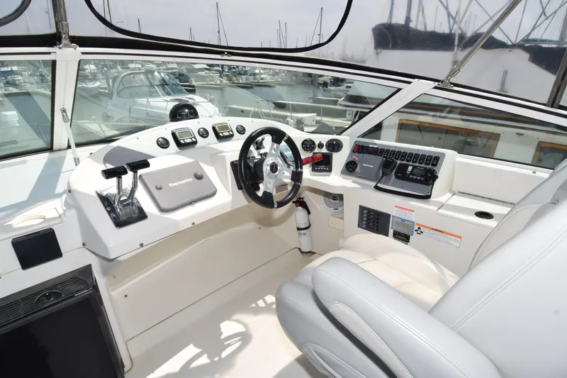 Slide: The Image of 2008 Carver 36 Mariner helm with modern controls and comfortable seating at marina. - 17