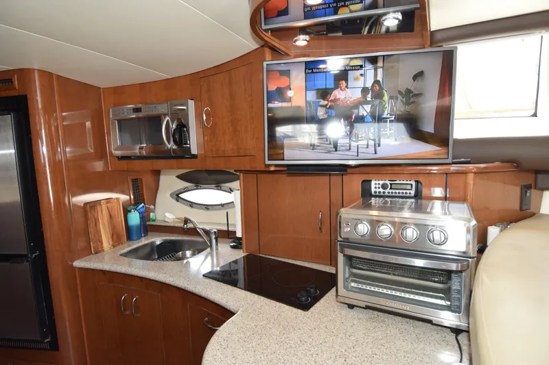 Slide: The Image of Interior of 2008 Carver 36 Mariner yacht with kitchen appliances and TV. - 2