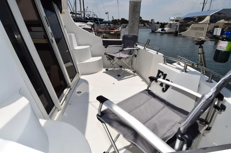 Slide: The Image of 2008 Carver 36 Mariner yacht deck with chairs, docked in marina. - 27