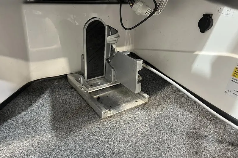 Slide: The Image of 2022 Bass Cat Bobcat boat pedal and wiring on carpeted floor. - 11