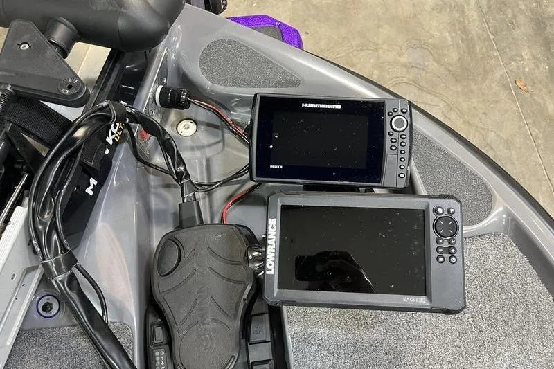 Slide: The Image of 2022 Bass Cat Bobcat boat dashboard with Humminbird and Lowrance fish finders. - 14