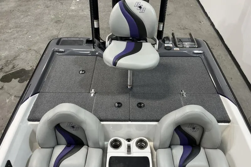 Slide: The Image of 2022 Bass Cat Bobcat boat interior with gray and purple seating, cup holders, and storage compartments. - 6