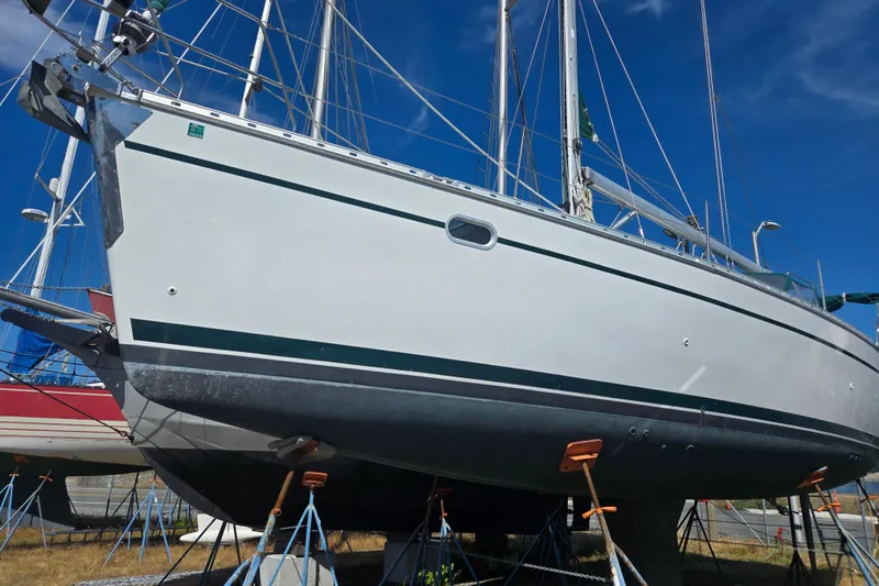 Slide: The Image of 2002 Jeanneau Sun Odyssey 43 DS sailboat on stands, clear blue sky background. - 1