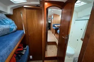 Slide: The Image of Interior of 2002 Jeanneau Sun Odyssey 43 DS sailboat, featuring wood paneling and cozy cabin layout. - 11