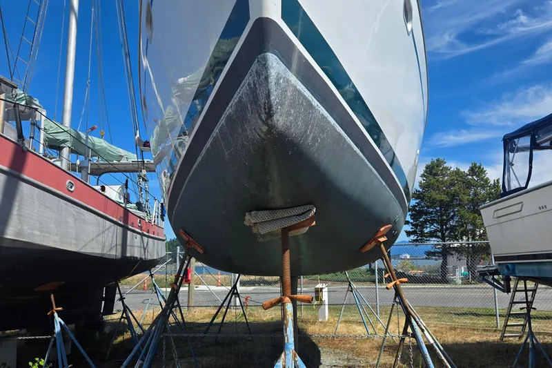 Slide: The Image of Jeanneau Sun Odyssey 43 DS sailboat on stands, 2002 model, in a boatyard. - 3