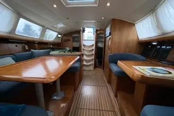 Slide: The Image of Interior of 2002 Jeanneau Sun Odyssey 43 DS sailboat with wooden furnishings and seating. - 5