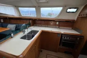 Slide: The Image of Interior of 2002 Jeanneau Sun Odyssey 43 DS yacht, featuring kitchen and dining area. - 6