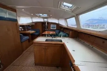 Slide: The Image of Interior of 2002 Jeanneau Sun Odyssey 43 DS sailboat, featuring spacious cabin and seating area. - 7