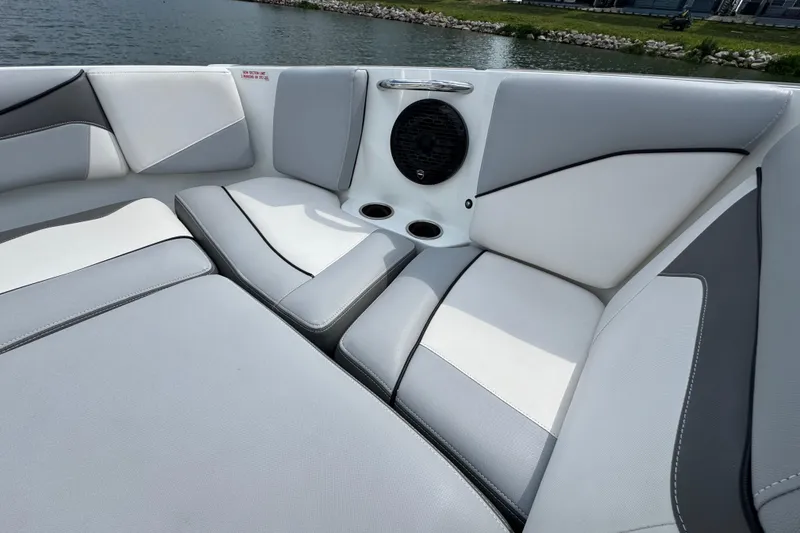 Slide: The Image of Luxurious seating on 2021 Supreme ZS232 boat, featuring sleek design and integrated speaker. - 13